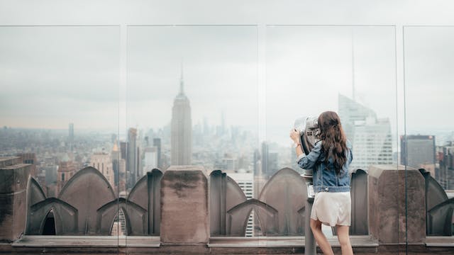 Woman looking at the NYC skyline.